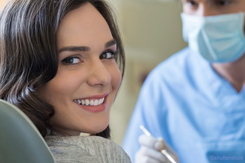 Woman in dental chair smiling