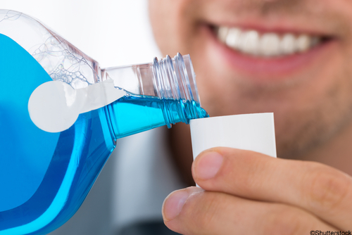 Man pouring mouthwash