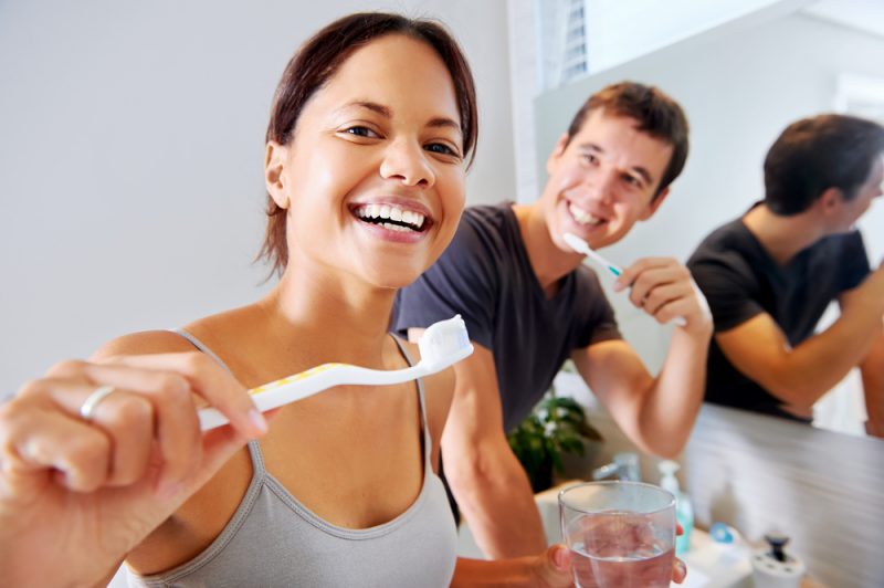 Couple brushing teeth