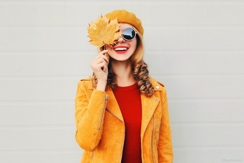 Woman smiling while wearing Autumn clothing