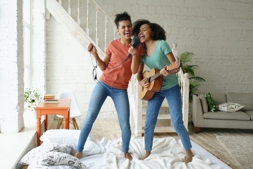 Two Girls Singing and Playing Guitar