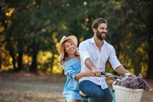 smiling couple on a bike with lavender in spring